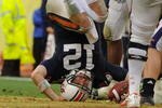 TAMPA, FL - JANUARY 1: Quarterback Chris Todd #12 of the Auburn Tigers tumbles for a sack against the Northwestern Wildcats in the Outback Bowl January 1, 2010 at Raymond James Stadium in Tampa, Florida.  (Photo by Al Messerschmidt/Getty Images) 