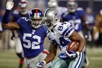 EAST RUTHERFORD, NJ - DECEMBER 06:  Patrick Crayton #84 of the Dallas Cowboys runs the ball against Michael Boley #52 of the New York Giants on December 6, 2009 at Giants Stadium in East Rutherford, New Jersey.  (Photo by Jim McIsaac/Getty Images)