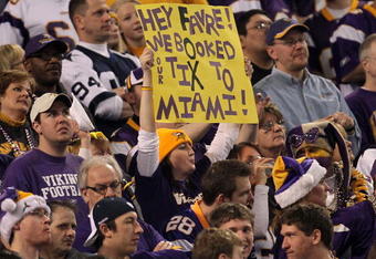 MINNEAPOLIS - JANUARY 17:  A fan of the Minnesota Vikings holds a sign that reads 'Hey Favre! We Booked Tix to Miami' during the game against the Dallas Cowboys during the NFC Divisional Playoff Game at Hubert H. Humphrey Metrodome on January 17, 2010 in Minneapolis, Minnesota.  The Vikings defeated the Cowboys 34-3.  (Photo by Chris McGrath/Getty Images)
