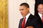 WASHINGTON - JANUARY 25:  President Barack Obama carries a basketball signed by members of the National Basketball Association 2009 champions Los Angeles Lakers during an event with the team in the East Room of the White House January 25, 2010 in Washington, DC. The Lakers bested the Orlando Magic to win the NBA Finals in 2009.  (Photo by Chip Somodevilla/Getty Images)