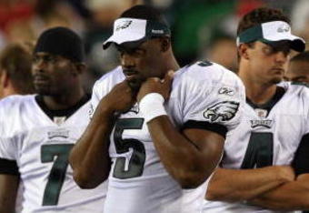 PHILADELPHIA - AUGUST 27:  Donovan McNabb #5, Michael Vick #7, and Kevin Kolb #4 of the Philadelphia Eagles look on from the sidelines against the Jacksonville Jaguars on August 27, 2009 at Lincoln Financial Field in Philadelphia, Pennsylvania.  (Photo by Jim McIsaac/Getty Images)