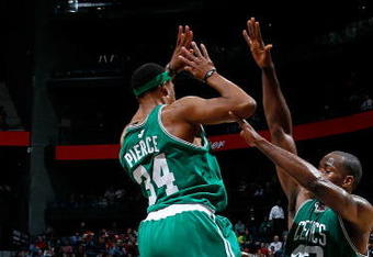 ATLANTA - JANUARY 29:  Kendrick Perkins #43 of the Boston Celtics defends as Paul Pierce #34 fouls Maurice Evans #1 of the Atlanta Hawks at Philips Arena on January 29, 2010 in Atlanta, Georgia.  NOTE TO USER: User expressly acknowledges and agrees that, by downloading and/or using this Photograph, User is consenting to the terms and conditions of the Getty Images License Agreement.  (Photo by Kevin C. Cox/Getty Images)