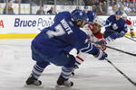 TORONTO - DECEMBER 26:  Ian White #7 of the Toronto Maple Leafs makes a pass play under pressure from Scott Gomez #91 of the Montreal Canadiens during their NHL game at the Air Canada Centre on December 26, 2009 in Toronto, Ontario, Canada. (Photo by Dave Sandford/Getty Images)