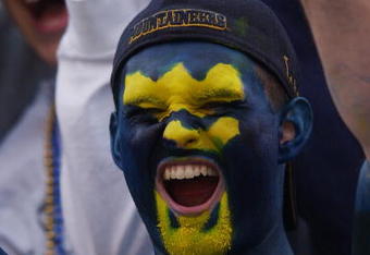 MORGANTOWN, WV - OCTOBER 26:  A fan of the West Virginia University Mountaineers cheers on his team during a Big East game against the University of Miami Hurricanes on October 26, 2002 at Mountaineer Field in Morgantown, West Virginia . Miami won 40-23.  (Photo By Doug Pensinger/Getty Images)