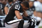 OAKLAND, CA - JANUARY 3:  Nnamdi Asomugha #21 of the Oakland Raiders sits on the bench against the Baltimore Ravens during an NFL game at Oakland-Alameda County Coliseum on January 3, 2010 in Oakland, California. (Photo by Jed Jacobsohn/Getty Images)