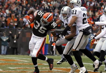 CLEVELAND - DECEMBER 27:  Jerome Harrison #35 of the Cleveland Browns scores a touchdown against Tyvon Branch #33 and Nnamdi Asomugha #21 of the Oakland Raiders at Cleveland Browns Stadium on December 27, 2009 in Cleveland, Ohio.  (Photo by Matt Sullivan/Getty Images)