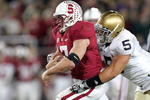 PALO ALTO, CA - NOVEMBER 28:  Toby Gerhart #7 of the Stanford Cardinal is tackled by Manti Te'o #5 of the Notre Dame Fighting Irish at Stanford Stadium on November 28, 2009 in Palo Alto, California.  (Photo by Ezra Shaw/Getty Images)