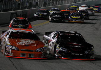IRWINDALE, CA - JANUARY 30:  Joey Logano driver of the #25 Home Depot Toyota battles Sergio Pena in the #4 Revolution Racing Chevrolet during  the NASCAR Toyota All-Star Showdow at Toyota Speedway  on January 30, 2010 in Irwindale, California.  (Photo by Jonathan Ferrey/Getty Images)