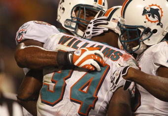 CHARLOTTE - NOVEMBER 19: Ricky Williams #34 of the Miami Dolphins celebrates with teammates after he scored on a 14 yard touchdown reception in the second quarter against the Carolina Panthers at Bank of America Stadium on November 19, 2009 in Charlotte, North Carolina.  (Photo by Streeter Lecka/Getty Images)