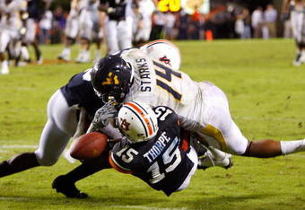 AUBURN, AL - SEPTEMBER 19:  Daren Bates #25 of the Auburn Tigers breaks up a pass between Neiko Thorpe #15 and Bradley Starks #14 of the West Virginia Mountaineers battle for a reception at Jordan-Hare Stadium on September 19, 2009 in Auburn, Alabama.  (Photo by Kevin C. Cox/Getty Images)