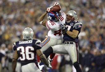 GLENDALE, AZ - FEBRUARY 03:  David Tyree #85 of the New York Giants catches a 32-yard pass from Eli Manning #10 against Rodney Harrison #37 and James Sanders #36 of the New England Patriots attempts to knock it out in the fourth quarter of Super Bowl XLII on February 3, 2008 at the University of Phoenix Stadium in Glendale, Arizona. The Giants won 17-14. (Photo by Andy Lyons/Getty Images)