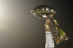 Tom Brady holds the Vince Lombardi Trophy as he stands on the podium after The New England Patriots defeated The Philadelphia Eagles in Super Bowl XXXIX at Alltel Staduim in Jacksonville, Florida.  (Photo by Al Messerschmidt/Getty Images)