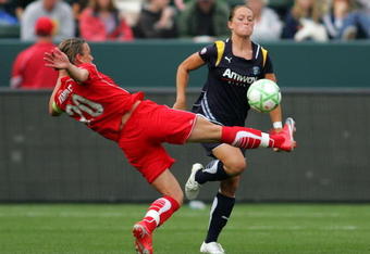 CARSON, CA - MARCH 29:  Brittany Bock #11 of the Los Angeles Sol tries to defend a play to the ball by Abby Wambach #20 of the Washington Freedom in the second half during the WPS game at The Home Depot Center on March 29, 2009 in Carson, California. The Sol defeated the Freedom 2-0. (Photo by Victor Decolongon/Getty Images)