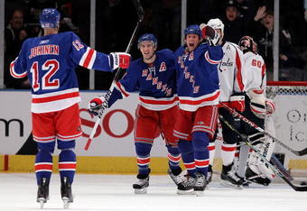 NEW YORK - FEBRUARY 04:  Ryan Callahan #24 (C) of the New York Rangers celebrates his first period goal against the Washington Capitals with teammate Vinny Prospal #20 and Olli Jokinen #12 on February 4, 2010 at Madison Square Garden in New York City.  (Photo by Jim McIsaac/Getty Images)