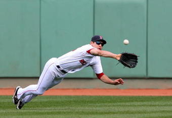 BOSTON - OCTOBER 11:  Jacoby Ellsbury #46 of the Boston Red Sox makes a diving catch on a Bobby Abreu #53 of the Los Angeles Angels of Anaheim flyout in the third inning of Game Three of the ALDS during the 2009 MLB Playoffs at Fenway Park on October 11, 2009 in Boston,  Massachusetts. (Photo by Jim Rogash/Getty Images)