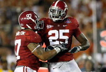 PASADENA, CA - JANUARY 07:  Lineman Lorenzo Washington #97 and linebacker Rolando McClain #25 of the Alabama Crimson Tide celebrate a play against the Texas Longhorns during the Citi BCS National Championship game at the Rose Bowl on January 7, 2010 in Pasadena, California.  (Photo by Jeff Gross/Getty Images)