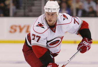 BOSTON - MAY 01:  Joe Corvo #77 of the Carolina Hurricanes looks to pass the puck against the Boston Bruins during Game One of the Eastern Conference Semifinal Round of the 2009 Stanley Cup Playoffs on May 1, 2009 at the TD Banknorth Garden in Boston, Massachusetts. The Bruins defeated the Hurricanes 4-1.  (Photo by Elsa/Getty Images)