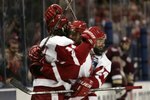 MILWAUKEE, WISCONSIN - APRIL 08:  Andrew Joudrey #24 and Robbie Earl #10 of the Wisconsin Badgers congratulate teammate Tom Gilbert #14 after he scored the game-winning goal in the third period during the NCAA Men's Frozen Four Championship game on April 8, 2006 at the Bradley Center in Milwaukee, Wisconsin. The Wisconsin Badgers defeated the Boston College Eagles 2-1 to win the national title.  (Photo by Elsa/Getty Images)