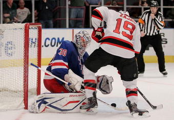 NEW YORK - FEBRUARY 06: Henrik Lundqvist #30 of the New York Rangers makes a save against Travis Zajac #19 of the New Jersey Devils during their game on February 6, 2010 at Madison Square Garden in New York City.  (Photo by Chris McGrath/Getty Images)