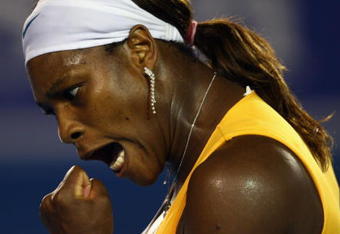MELBOURNE, AUSTRALIA - JANUARY 30:  Serena Williams of the United States of America celebrates winning a point in her women's final match against Justine Henin of Belgium during day thirteen of the 2010 Australian Open at Melbourne Park on January 30, 2010 in Melbourne, Australia.  (Photo by Clive Brunskill/Getty Images)