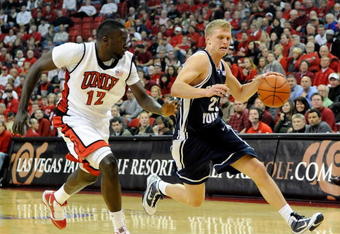 LAS VEGAS - FEBRUARY 06:  Tyler Haws #23 of the Brigham Young University Cougars drives against Brice Massamba #12 of the UNLV Rebels during their game at the Thomas & Mack Center February 6, 2010 in Las Vegas, Nevada. UNLV won 88-74.  (Photo by Ethan Miller/Getty Images)