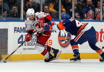 UNIONDALE, NY - FEBRUARY 06:  Ray Whitney #13 of the Carolina Hurricanes controls the puck from Andrew MacDonald #47 of the New York Islanders on February 6, 2010 at Nassau Coliseum in Uniondale, New York.  (Photo by Jim McIsaac/Getty Images)