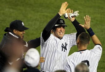 NEW YORK - NOVEMBER 04:  Mark Teixeira #25 (C) and Derek Jeter #2 of the New York Yankees celebrate after Teixeira scored in the bottom of the fifth inning against the Philadelphia Phillies in Game Six of the 2009 MLB World Series at Yankee Stadium on November 4, 2009 in the Bronx borough of New York City.  (Photo by Al Bello/Getty Images)