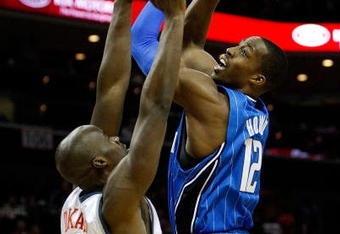 CHARLOTTE, NC - FEBRUARY 20:  Dwight Howard #12 of the Orlando Magic shoots the ball over Emeka Okafor #50 of the Charlotte Bobcats during their game at Time Warner Cable Arena on February 20, 2009 in Charlotte, North Carolina. NOTE TO USER: User expressly acknowledges and agrees that, by downloading and/or using this Photograph, user is consenting to the terms and conditions of the Getty Images License Agreement.  (Photo by Streeter Lecka/Getty Images)