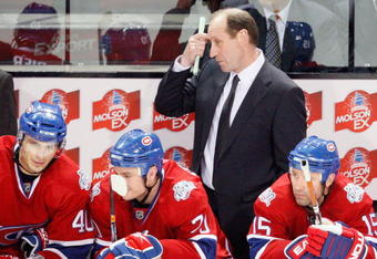 MONTREAL- MARCH 10:  Montreal Canadiens head coach Bob Gainey watches play behind Maxim Lapierre  #40, Gregory Stewart #70 and Glen Metropolit #15 during the game against the Edmonton Oilers at the Bell Centre on March 10, 2009 in Montreal, Quebec, Canada.  The Canadiens defeated the Oilers 4-3 in overtime.  (Photo by Richard Wolowicz/Getty Images)