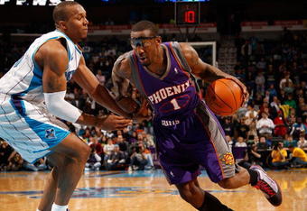 NEW ORLEANS - FEBRUARY 01:  Amar'e Stoudemire #1 of the Phoenix Suns drives the ball around David West #30 of the New Orleans Hornets at the New Orleans Arena on February 1, 2010 in New Orleans, Louisiana.  The Suns defeated the Hornets 109-100.  NOTE TO USER: User expressly acknowledges and agrees that, by downloading and/or using this Photograph, User is consenting to the terms and conditions of the Getty Images License Agreement.  (Photo by Chris Graythen/Getty Images)