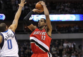 DALLAS - JANUARY 30:  Forward LaMarcus Aldridge #12 of the Portland Trail Blazers takes a shot against Shawn Marion #0 of the Dallas Mavericks on January 30, 2010 at American Airlines Center in Dallas, Texas.  NOTE TO USER: User expressly acknowledges and agrees that, by downloading and/or using this Photograph, user is consenting to the terms and conditions of the Getty Images License Agreement.  (Photo by Ronald Martinez/Getty Images)