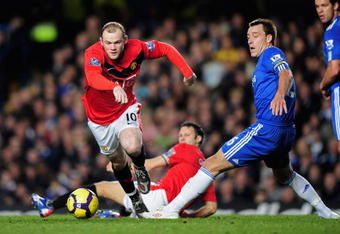 LONDON, ENGLAND - NOVEMBER 08:  Wayne Rooney of Manchester United goes past the challenge from John Terry of Chelsea during the Barclays Premier League match between Chelsea and Manchester United at Stamford Bridge on November 8, 2009 in London, England.  (Photo by Clive Mason/Getty Images)