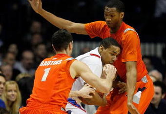 ROSEMONT, IL - JANUARY 30: Mike Stovall #1 of the DePaul Blue Demons tries to control the ball under pressure from Andy Rautins #1 and Wes Johnson #4 of the Syracuse Orange at the Allstate Arena on January 30, 2010 in Rosemont, Illinois. Syracuse defeated DePaul 59-57. (Photo by Jonathan Daniel/Getty Images)
