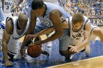 DURHAM, NC - FEBRUARY 07:  DeMarcus Nelson #21, left, and Greg Paulus #3, right, of the Duke University Blue Devils battle Deon Thompson #21 of the North Carolina Tar Heels for a loose ball during their game on February 7, 2007 at Cameron Indoor Stadium in Durham, North Carolina.  (Photo by Grant Halverson/Getty Images)