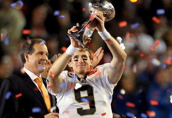 MIAMI GARDENS, FL - FEBRUARY 07:  Drew Brees #9 of the New Orleans Saints celebrates with the Vince Lombardi trophy at the end of Super Bowl XLIV on February 7, 2010 at Sun Life Stadium in Miami Gardens, Florida. The Saints defeated the Colts 31-17.  (Photo by Ezra Shaw/Getty Images)