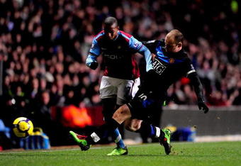 BIRMINGHAM, ENGLAND - FEBRUARY 10:  Wayne Rooney (R) of Manchester United tackles Ashley Young of Aston Villa during the Barclays Premier League match between Aston Villa and Manchester United at Villa Park on February 10, 2010 in Birmingham, England.  (Photo by Jamie McDonald/Getty Images)