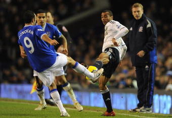LIVERPOOL, ENGLAND - FEBRUARY 10:  Ashley Cole of Chelsea is challenged by Landon Donovan of Everton during the Barclays Premier League match between Everton and Chelsea at Goodison Park on February 10, 2010 in Liverpool, England.  (Photo by Michael Regan/Getty Images)
