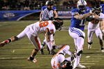 LAS VEGAS - DECEMBER 22:  Manase Tonga #11 of the Brigham Young University Cougars gets by Suaesi Tuimaunei #28 and Anthony Watkins #47 of the Oregon State Beavers en route to scoring a touchdown in the fourth quarter of the MAACO Las Vegas Bowl at Sam Boyd Stadium December 22, 2009 in Las Vegas, Nevada. The Cougars won 44-20.  (Photo by Ethan Miller/Getty Images)