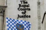 LONDON, ENGLAND - FEBRUARY 10:  Portsmouth football club fan David Maples waves a club flag outside the High Court on February 10, 2010 in London, England. Portsmouth FC have seven days to provide a 'statement of financial affairs' proving they can pay their creditors to avoid a winding-up petition.  (Photo by Oli Scarff/Getty Images)