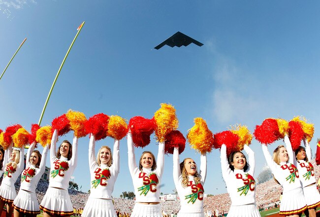 PASADENA, CA - JANUARY 01:  The USC Trojans cheerleaders stand on the field as the B1 Bomber plane flies overhead prior to the 95th Rose Bowl Game presented by Citi against the Penn State Nittany Lions on January 1, 2009 at the Rose Bowl in Pasadena, California.  (Photo by Harry How/Getty Images)
