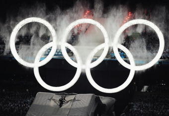 VANCOUVER, BC - FEBRUARY 12:  A snowboarder leaps through the Olympic Rings to begin the Opening Ceremony of the 2010 Vancouver Winter Olympics at BC Place on February 12, 2010 in Vancouver, Canada.  (Photo by Jasper Juinen/Getty Images)