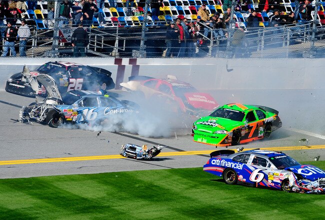 DAYTONA BEACH, FL - FEBRUARY 13:  Danica Patrick, driver of the #7 GoDaddy.com Chevrolet, Colin Braun, driver of the #16 Con-way Freight Ford and Ricky Stenhouse Jr., driver of the #6 CitiFinancial Ford, crash during the NASCAR Nationwide Series Drive4COPD 300 at Daytona International Speedway on February 13, 2010 in Daytona Beach, Florida.  (Photo by Sam Greenwood/Getty Images)