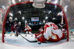 VANCOUVER, BC - FEBRUARY 14:  Meghan Duggan of the United States fights for a loose puck in the crease against Yao Shi #30 of China during their women's ice hockey preliminary game at UBC Thunderbird Arena on February 14, 2010 in Vancouver, Canada.   (Photo by Gene J. Puskar-Pool/Getty Images)