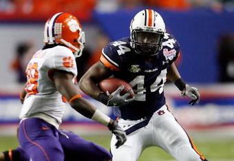 ATLANTA - DECEMBER 31:  Ben Tate #44 of the Auburn University Tigers runs against Chris Chancellor #38 of the Clemson University Tigers during the Chick-Fil-A Bowl on December 31, 2007 at the Georgia Dome in Atlanta, Georgia.  (Photo by Chris Graythen/Getty Images)