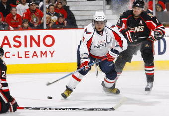 OTTAWA, ON - FEBRUARY 11:  Alex Ovechkin #8 of the Washington Capitals tries to deke in between Anton Volchenkov #24 and Chris Phillips #4 of the Ottawa Senators in a game at Scotiabank Place on February 11, 2010 in Ottawa, Canada. The Ottawa Senators lead the Washington Capitals 3-1 after one period. (Photo by Phillip MacCallum/Getty Images)
