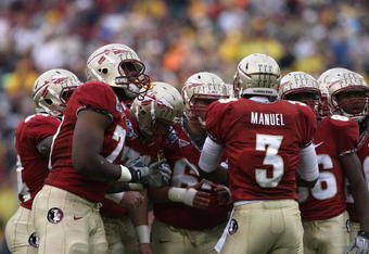 JACKSONVILLE, FL - JANUARY 01:  Quarterback E.J. Manuel #3 of the Florida State Seminoles calls out a play in the huddle against the West Virginia Mountaineers during the Konica Minolta Gator Bowl on January 1, 2010 at Jacksonville Municipal Stadium in Jacksonville, Florida. Florida State defeated West Virginia 33-21 in Bobby Bowden's last game as a head coach for the Seminoles.  (Photo by Doug Benc/Getty Images)