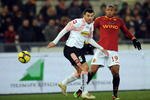 ROME - FEBRUARY 13: Cesare Bovo (L) of Palermo and Julio Baptista of Roma compete for the ball during the Serie A match between AS Roma and US Citta di Palermo at Stadio Olimpico on February 13, 2010 in Rome, Italy.  (Photo by Tullio Puglia/Getty Images)