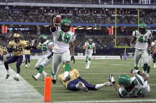 TORONTO - NOVEMBER 25:  James Johnson #19 of the Saskatchewan Rough Riders jumps over a fallen Ryan Dinwiddie #4 after his interception to score a touchdown to tie the game 7-7 against the Winnipeg Blue Bombers during the second quarter of the 95th Grey Cup on November 25, 2007 at the Rogers Centre in Toronto, Ontario, Canada.  Johnson would be the MVP in a 23-19 Rough Rider win.  (Photo by Harry How/Getty Images)