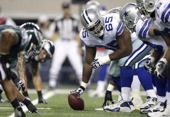 ARLINGTON, TX - JANUARY 9:  Center Andre Gurode #65 of the Dallas Cowboys looks down the line of scrimmage before snapping the ball against the Philadelphia Eagles in the 2010 NFC wild-card playoff game at Cowboys Stadium on January 9, 2010 in Arlington, Texas. (Photo by Jamie Squire/Getty Images)