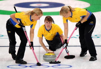 VANCOUVER, BC - FEBRUARY 16:  Cathrine Lindahl (C) of Sweden releases her stone during the women's curling round robin game between Denmark and Sweden on day 5 of the Vancouver 2010 Winter Olympics at Vancouver Olympic Centre on February 16, 2010 in Vancouver, Canada.  (Photo by Cameron Spencer/Getty Images)